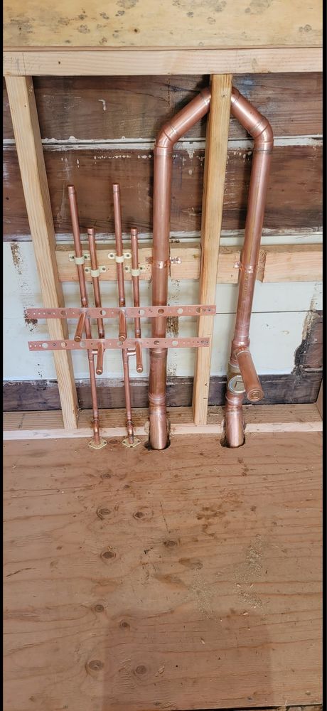 Precision-fabricated copper repipe manifold staged and ready for wall installation
